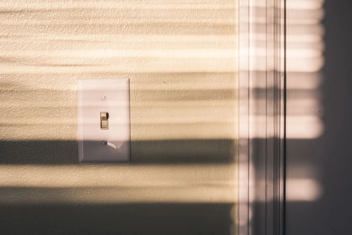 A faulty light switch on a wall inside a home.