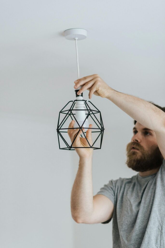 a Coatesville, PA electrician installing a new light fixture