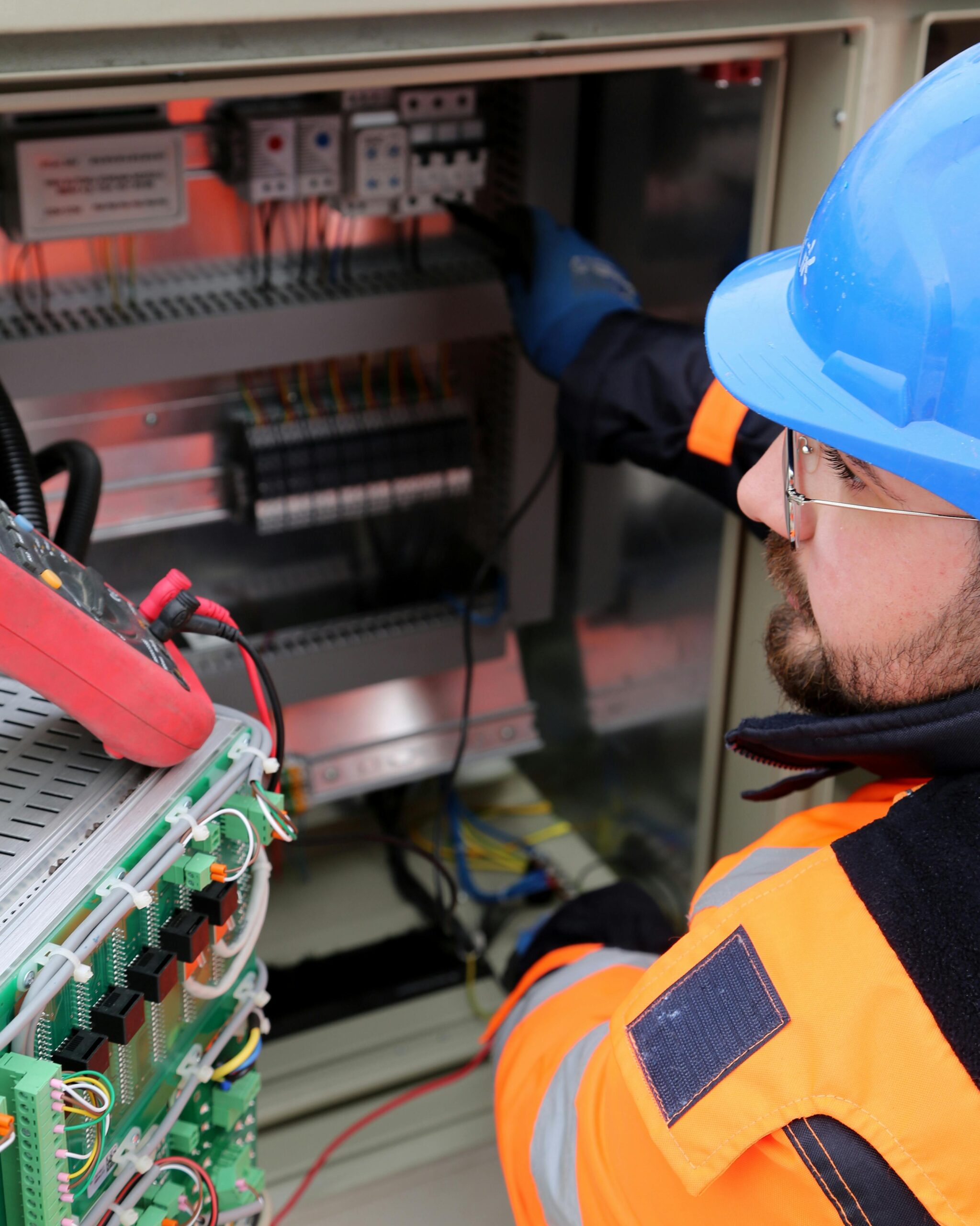 A closeup of an Oxford, PA electrician working on an electrical panel