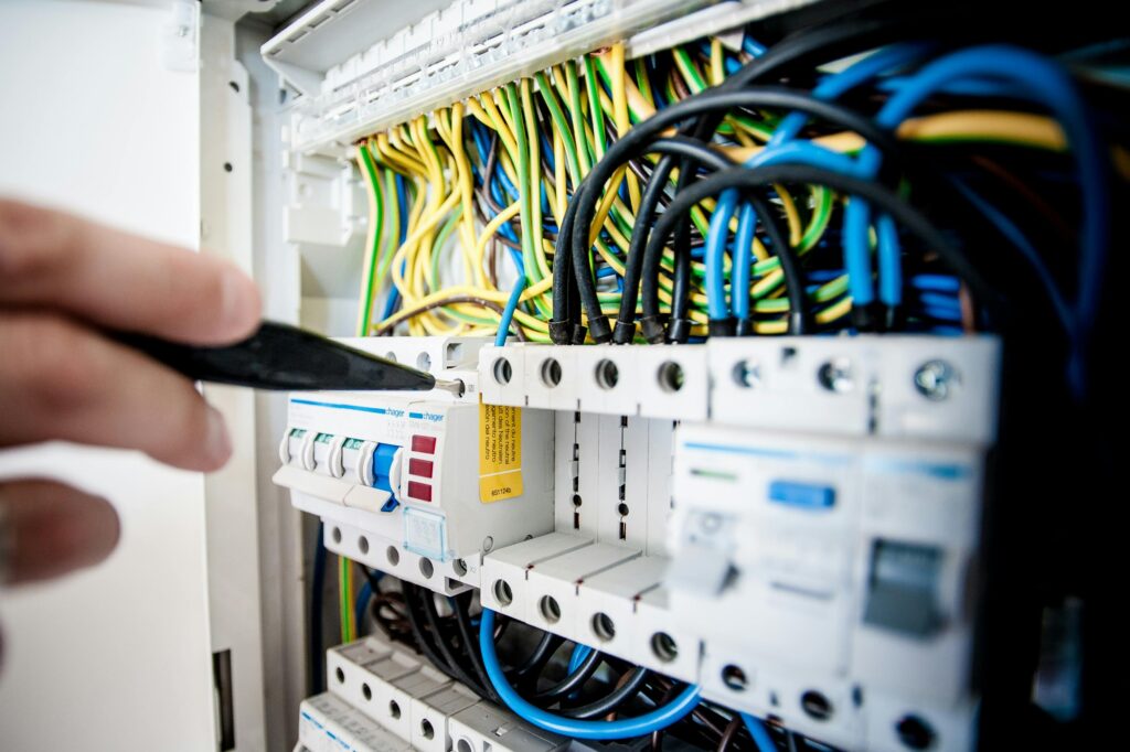a closeup of a professional electrician working on an ecircuit breaker panel