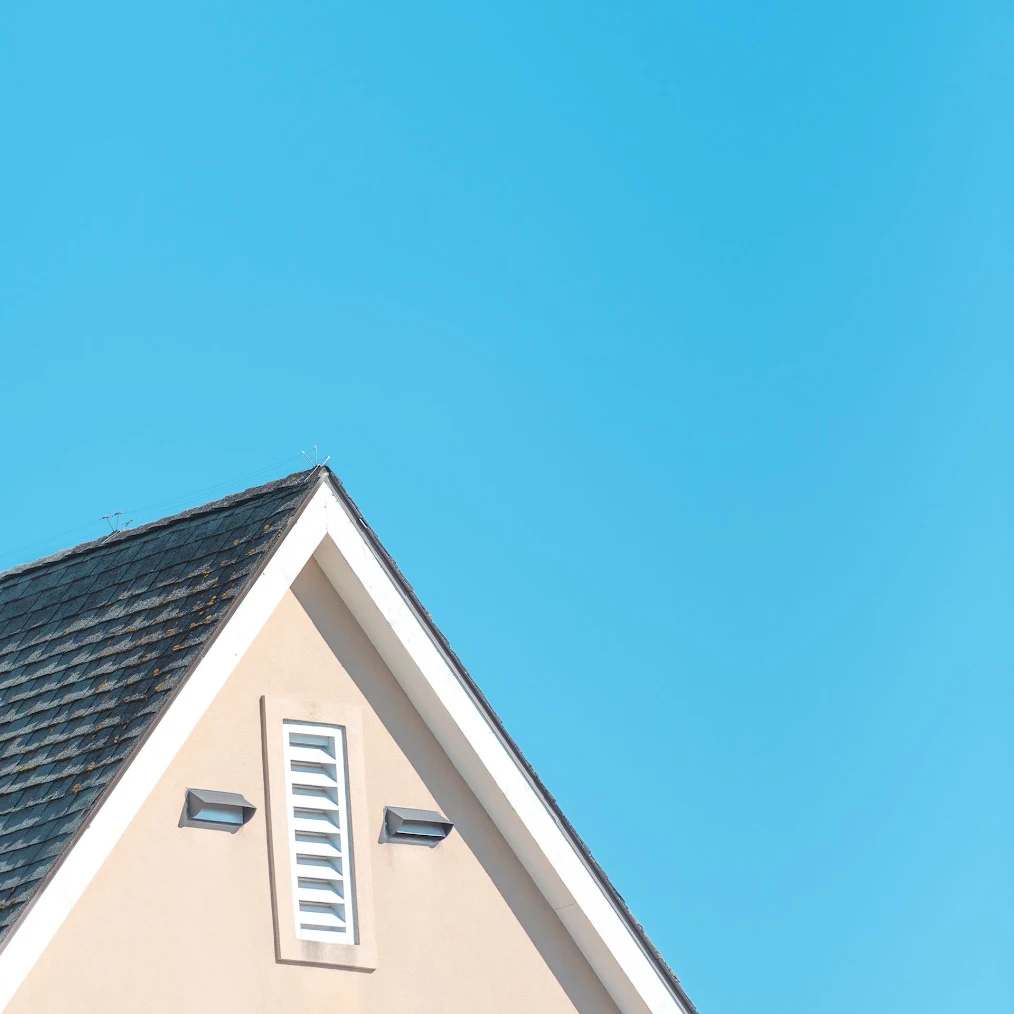 The outside of an attic with exhaust vents.
